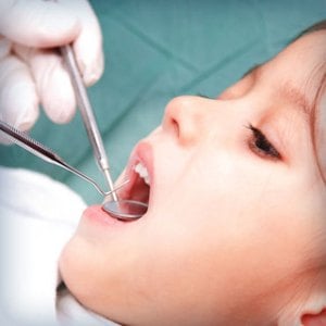 Child having her teeth cleaned